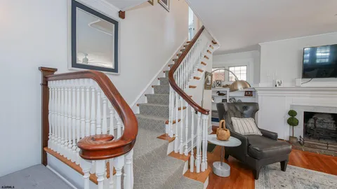 a view of hall way with furniture and fireplace