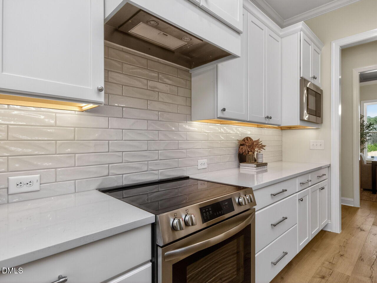 6044 Scalybark Road Durham, NC 27712 - Photo 18 of 39 a kitchen with white cabinets and white appliances