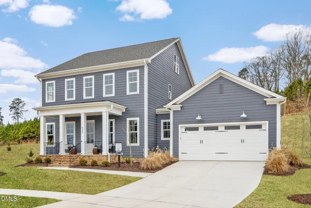 a view of a house with a yard and plants