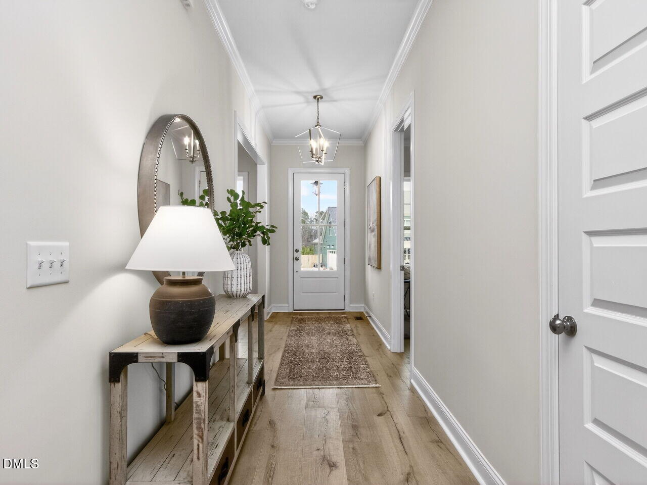6044 Scalybark Road Durham, NC 27712 - Photo 5 of 39 a view of entryway with wooden floor