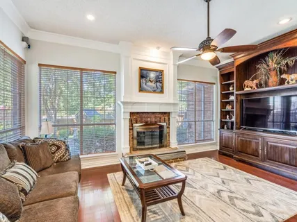 a living room with furniture a flat screen tv and a fireplace