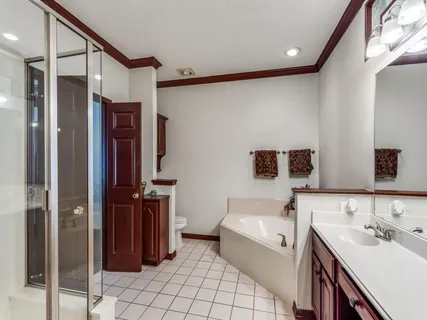 a bathroom with a bathtub sink and mirror