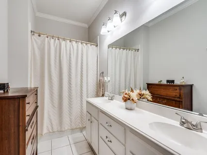 a bathroom with a double vanity sink and a mirror