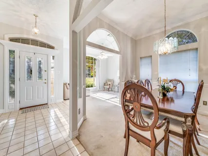 a dining room with furniture and chandelier