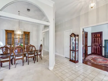 a dining room with furniture and chandelier