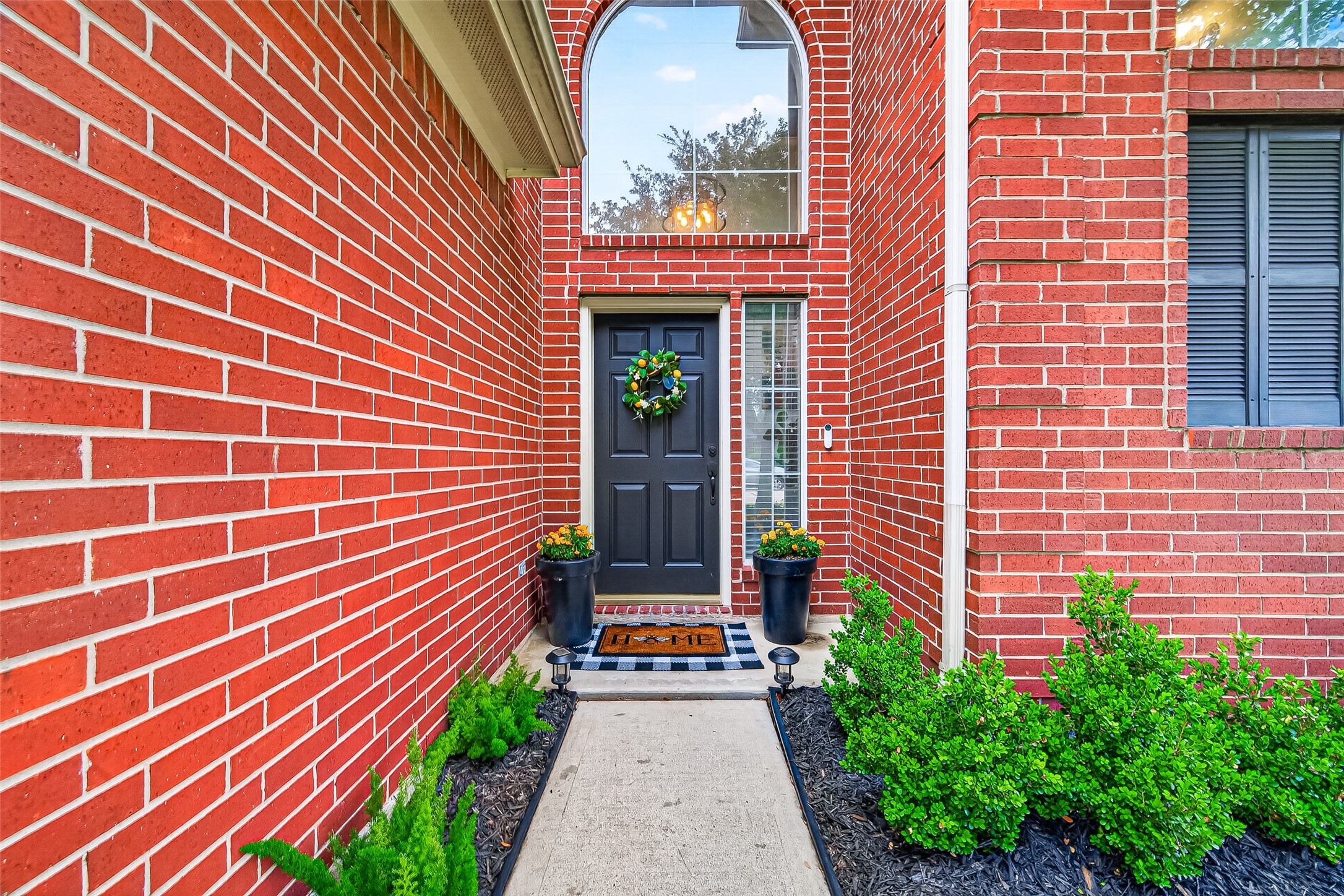 7415 Riven Oaks Court Cypress, TX 77433 - Photo 5 of 42 Welcoming entryway features a stylish black front door complemented by elegant glass side panels and a transom window that fills the home with natural light.