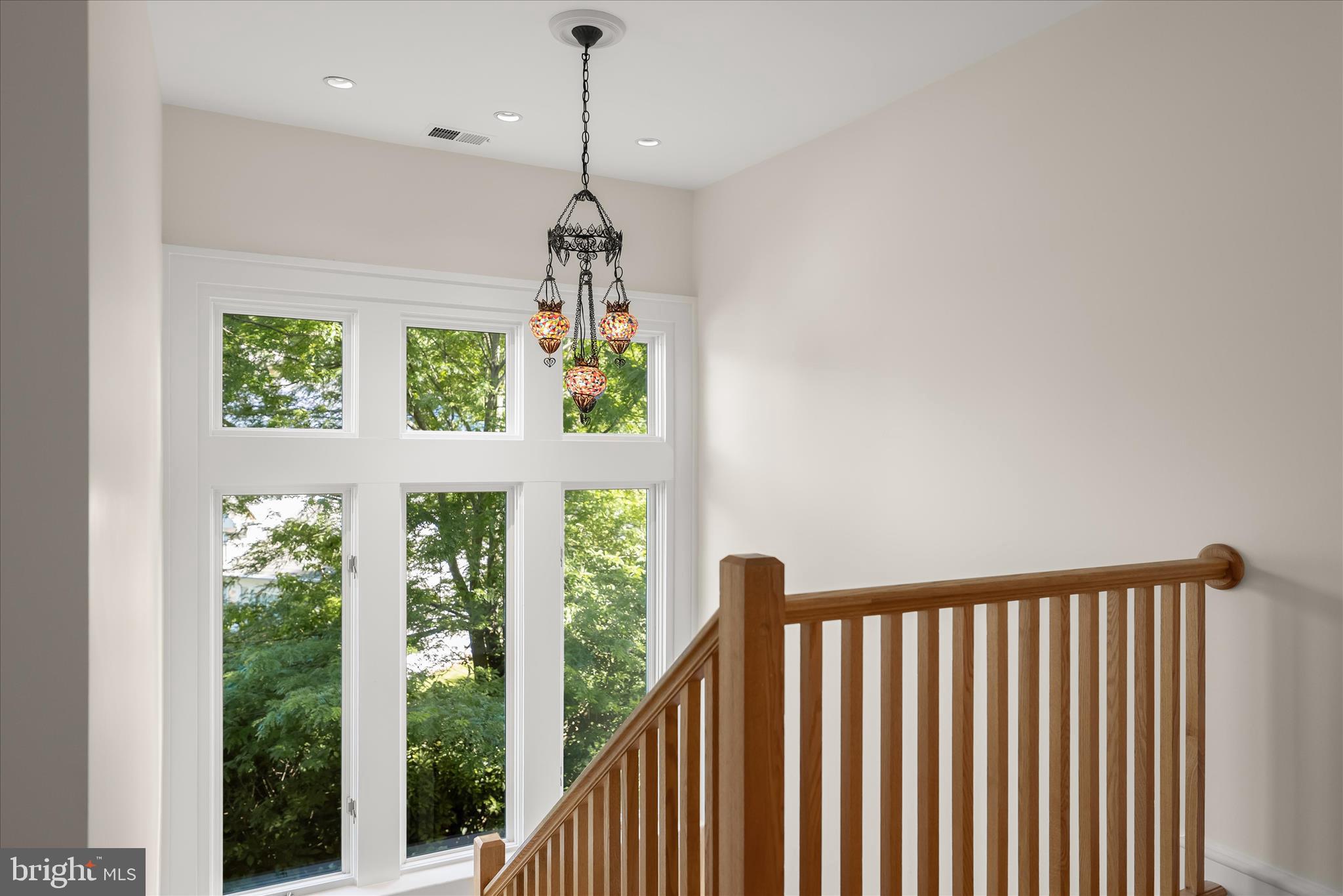 5104 Scarsdale Road Bethesda, MD 20816 - Photo 30 of 68 a view of a room with wooden floor windows and a chandelier