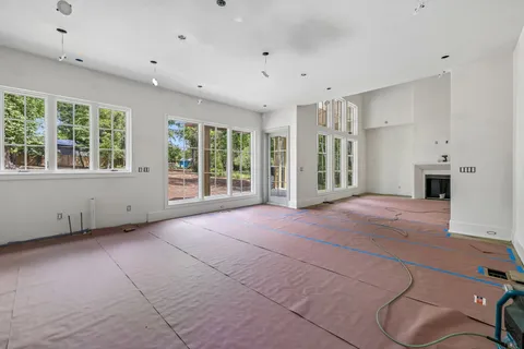 a dining room with furniture a chandelier and wooden floor