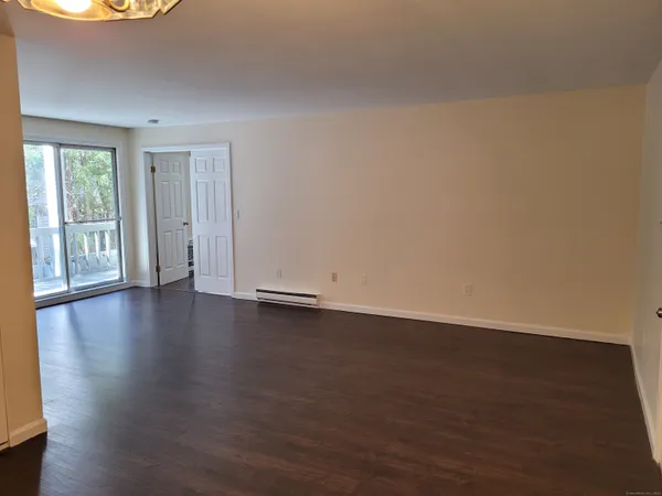 a view of room with hardwood floor and window