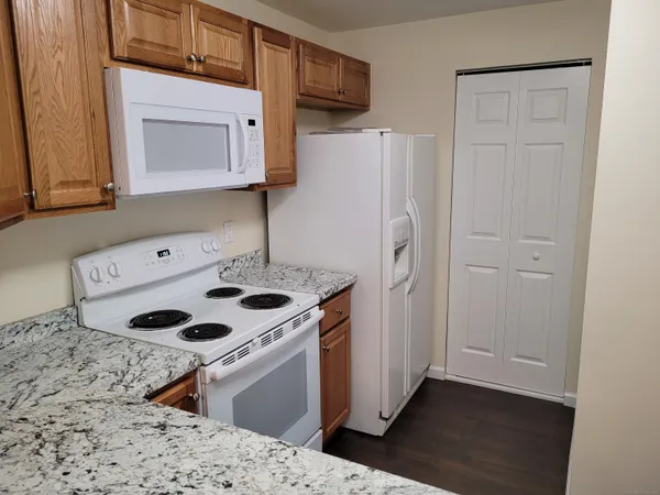 a kitchen with granite countertop a sink and a stove top oven