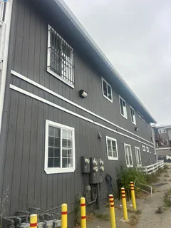 a front view of a building with parking space