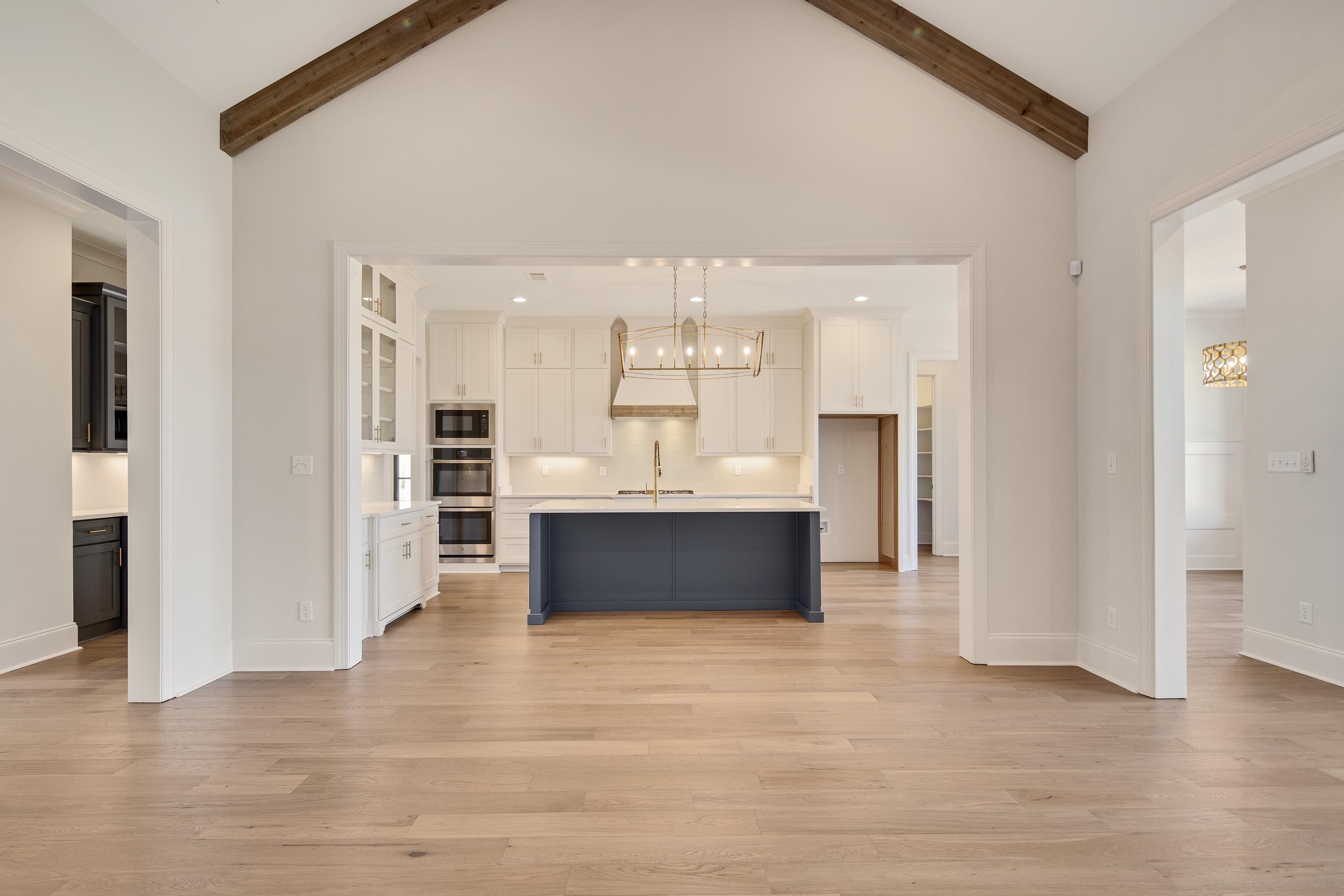 1207 Pipit Drive Collierville, TN 38017 - Photo 11 of 35 a living room with stainless steel appliances kitchen island granite countertop a refrigerator and a sink