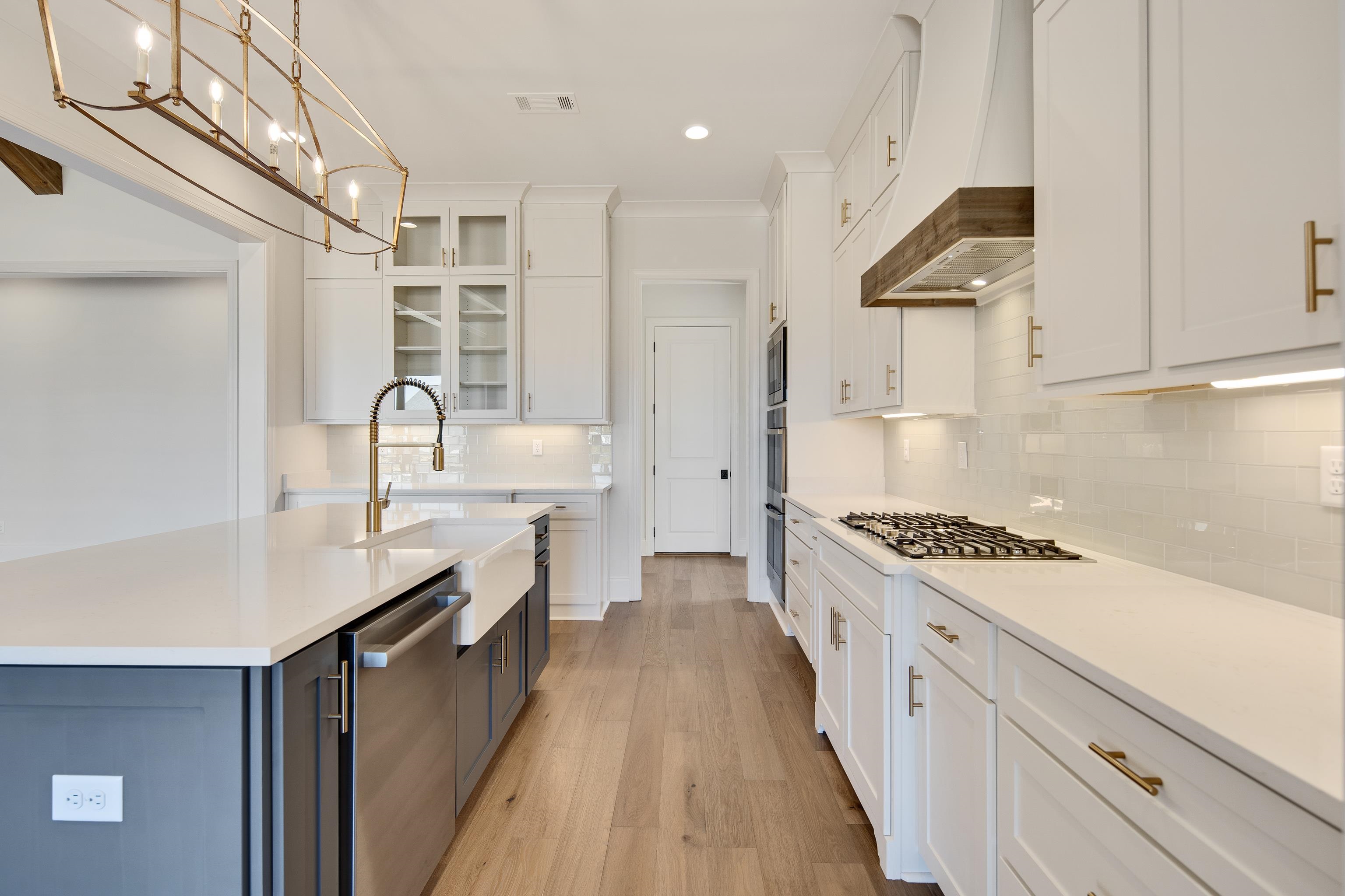1207 Pipit Drive Collierville, TN 38017 - Photo 13 of 35 a kitchen with stainless steel appliances granite countertop a sink stove and refrigerator