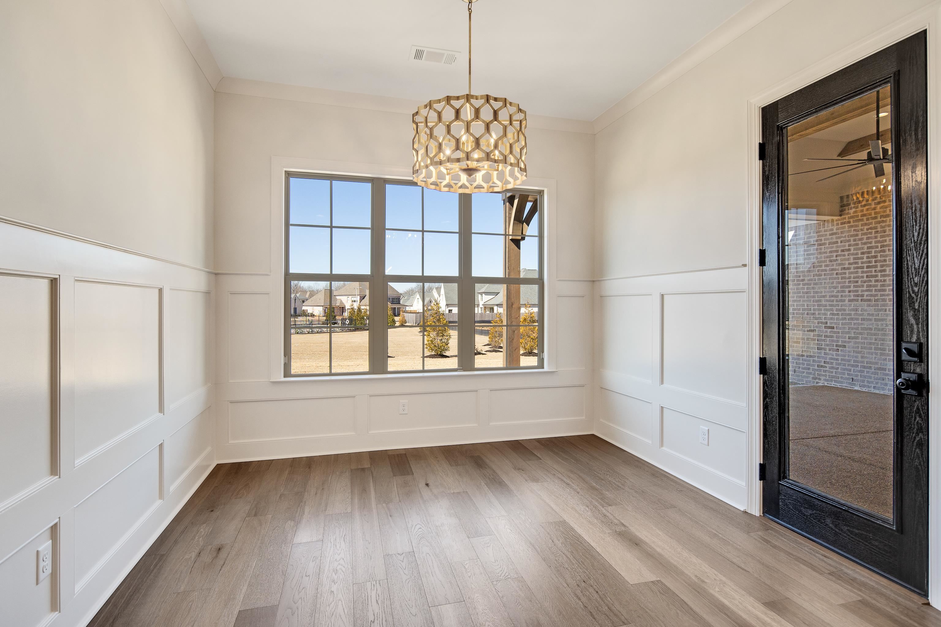 1207 Pipit Drive Collierville, TN 38017 - Photo 14 of 35 a view of an empty room with wooden floor and a window