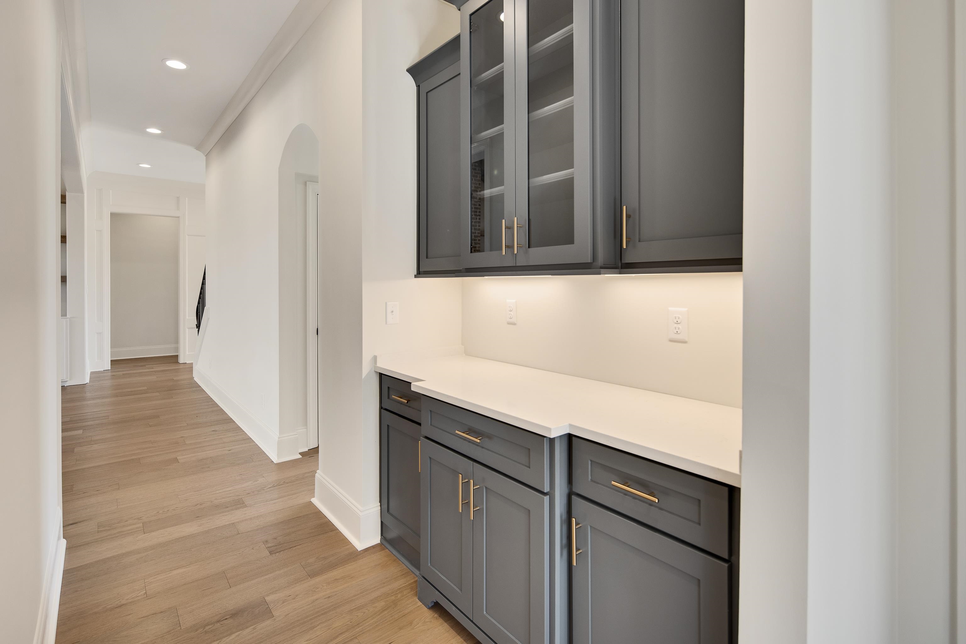 1207 Pipit Drive Collierville, TN 38017 - Photo 17 of 35 a hallway with wooden floor and cabinets