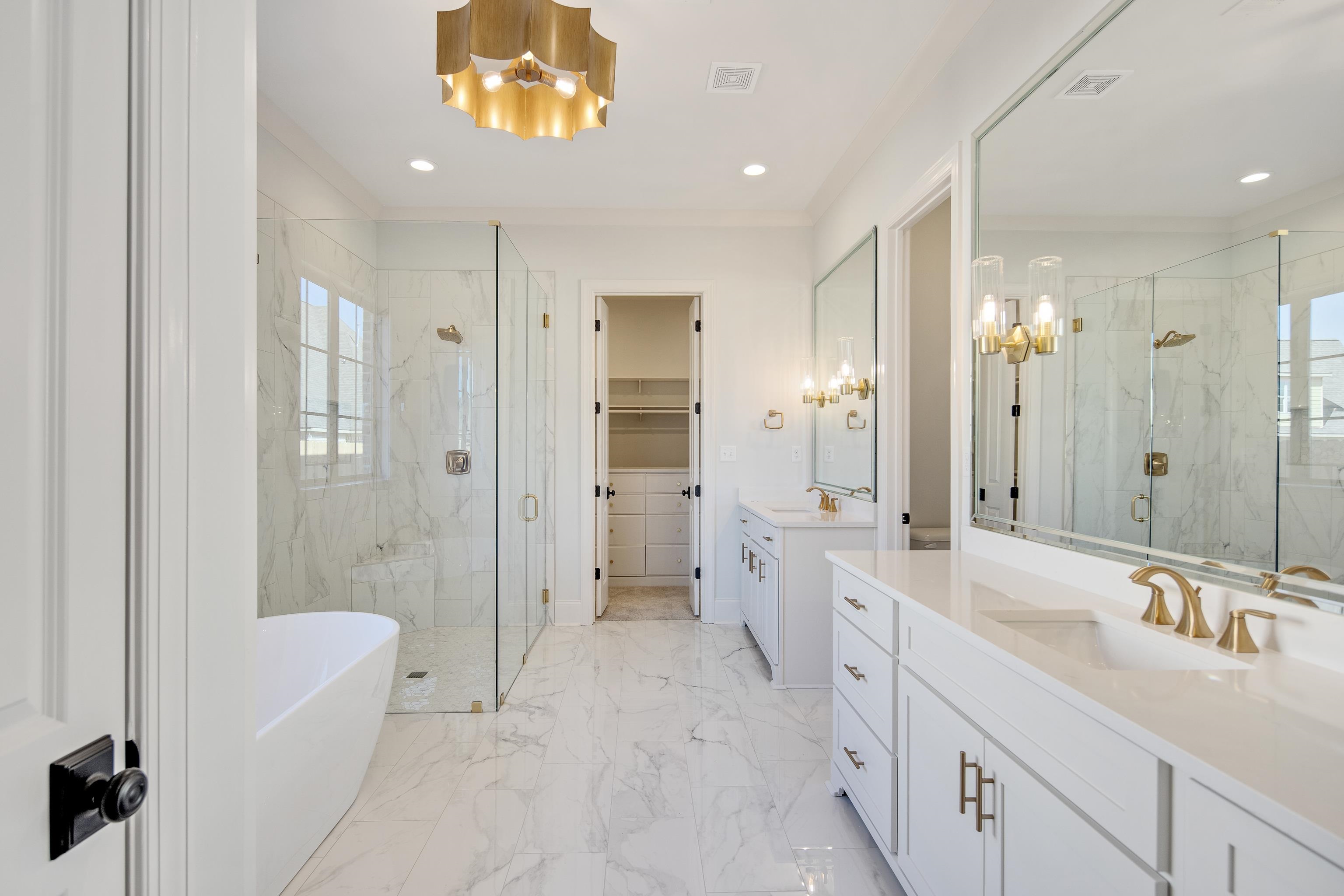 1207 Pipit Drive Collierville, TN 38017 - Photo 19 of 35 a spacious bathroom with a bathtub shower sink vanity and mirror
