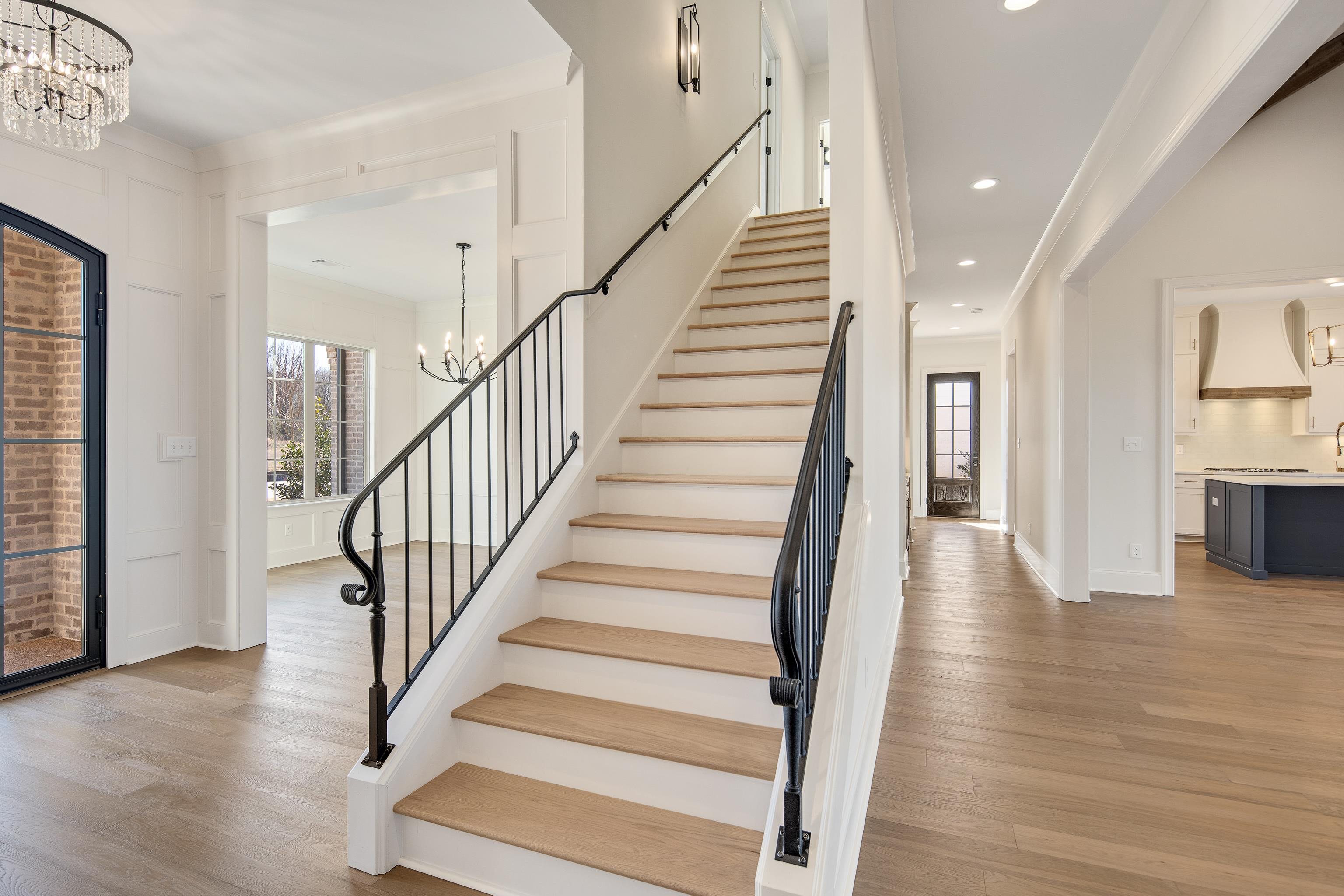1207 Pipit Drive Collierville, TN 38017 - Photo 25 of 35 a view of staircase with wooden floor and a chandelier