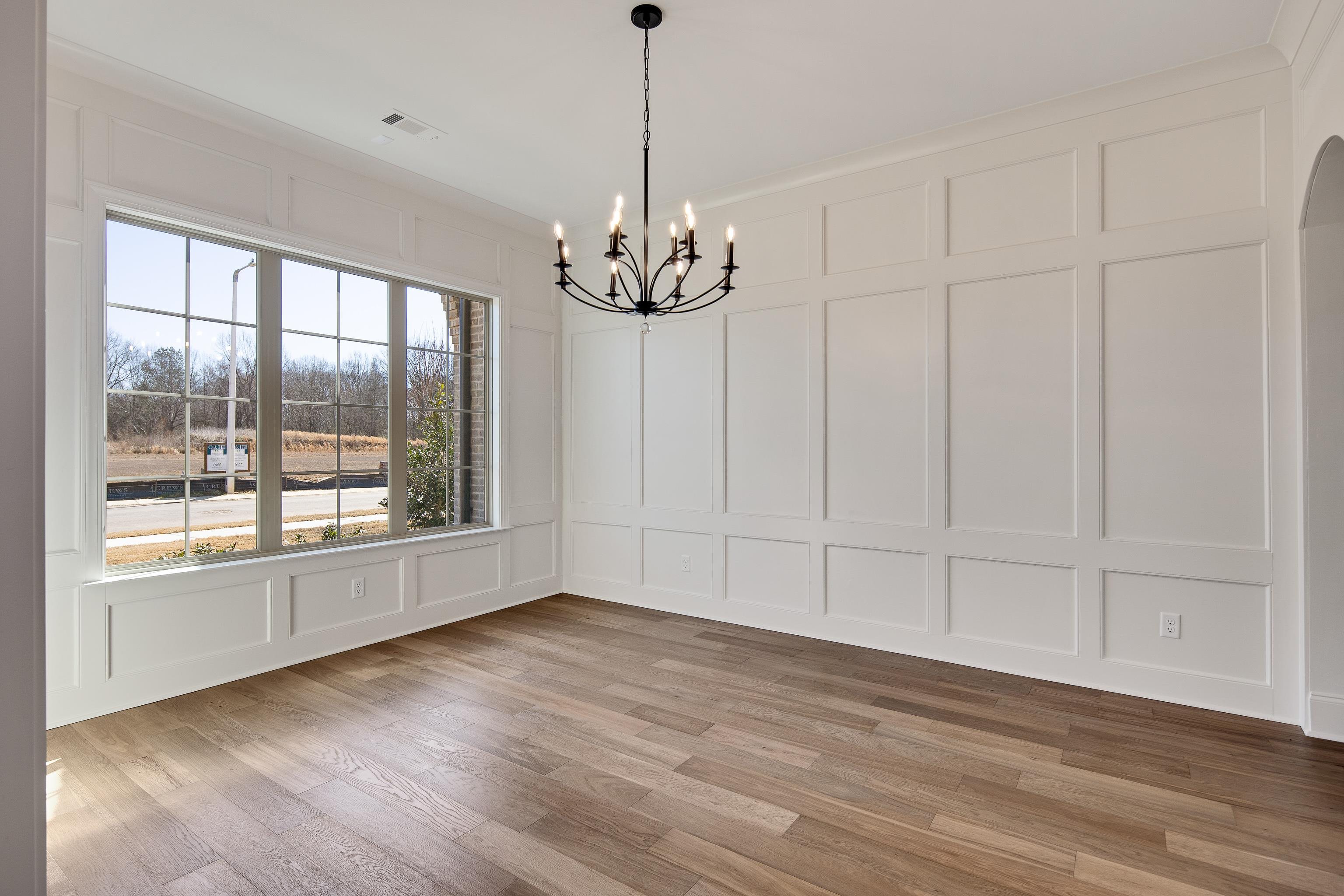 1207 Pipit Drive Collierville, TN 38017 - Photo 6 of 35 a view of an empty room with wooden floor and a window