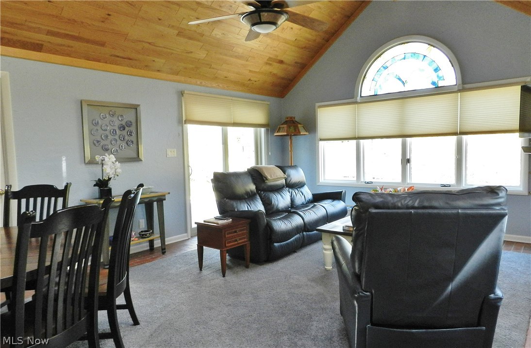 30065 Bolingbrook Road Pepper Pike, OH 44124 - Photo 10 of 33 Off the kitchen is the Great Room with vaulted ceiling and slider doors to the wrap around deck. The room's generous size has space for a casual dining table as well as furniture groupings. Note the ceiling fan, wood ceiling and the decorative window.