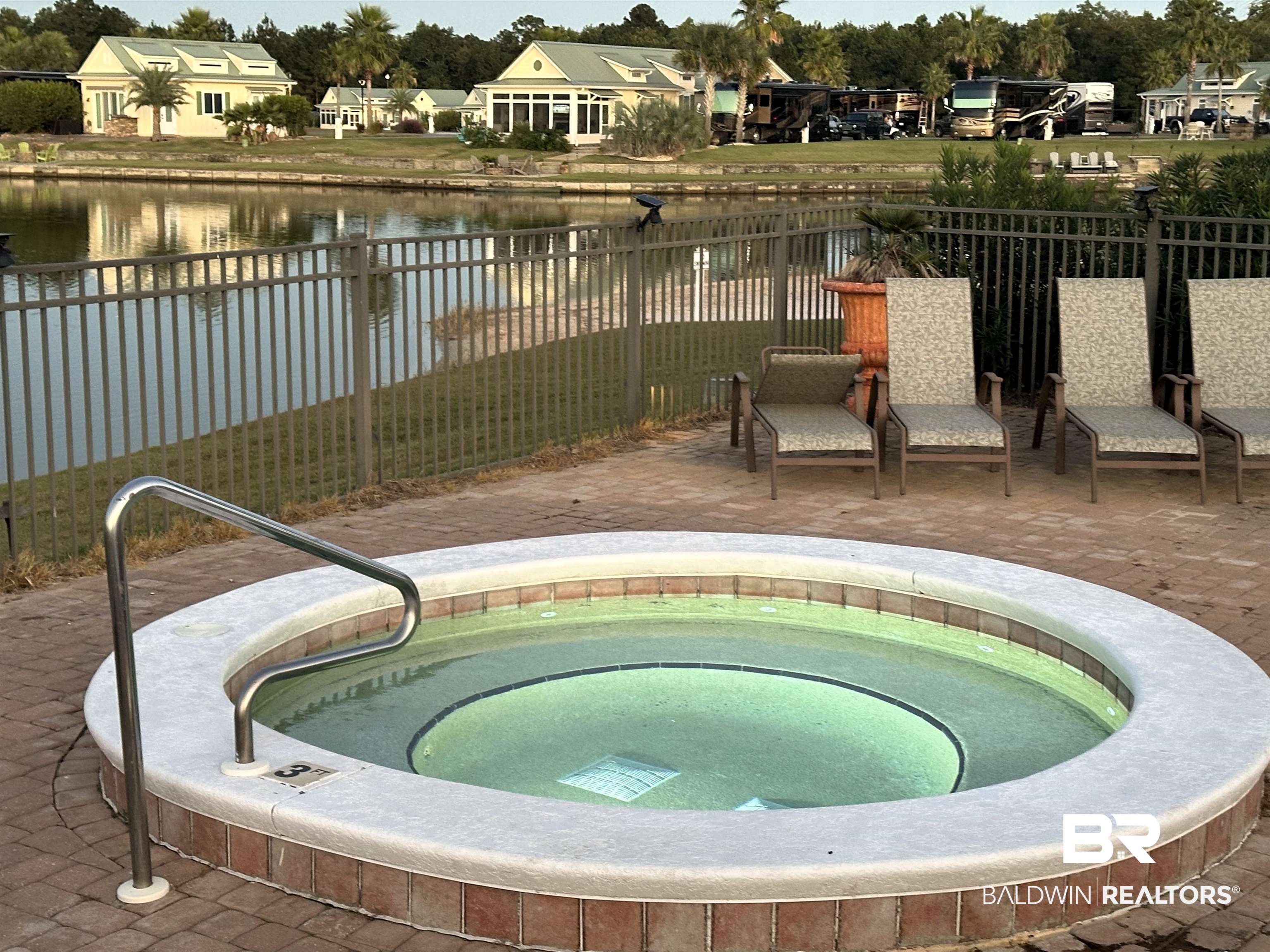 11869 Gateway Drive Elberta, AL 36530 - Photo 38 of 78 Exterior space featuring a hot tub, a water view, a residential view, and a fenced backyard