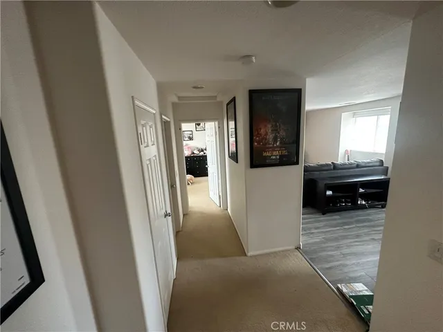 a view of a hallway view with wooden floor and living room
