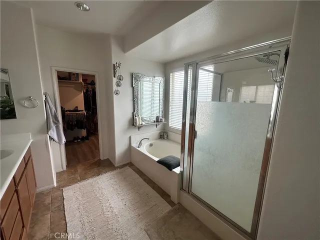 a bathroom with a tub shower and a sink