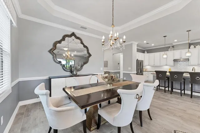 a bathroom with a tub a sink and large window