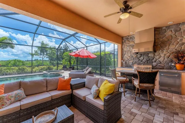 an aerial view of residential houses with outdoor space and trees