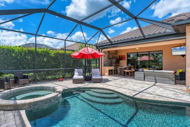 an aerial view of residential houses with outdoor space and ocean view
