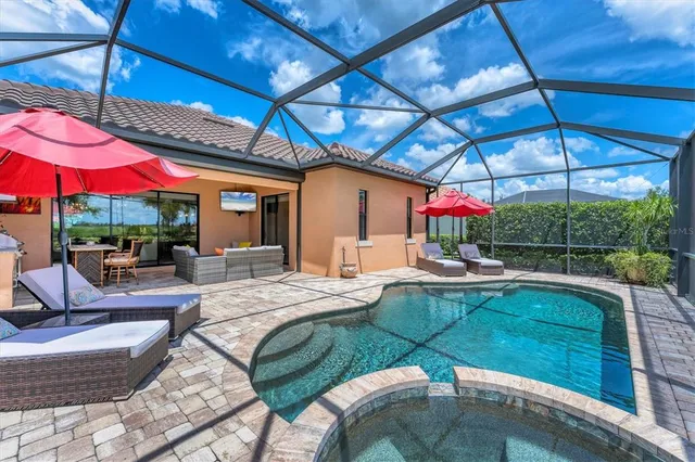 an aerial view of a house with a garden and lake view