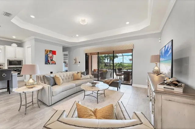 a living room with furniture and a chandelier