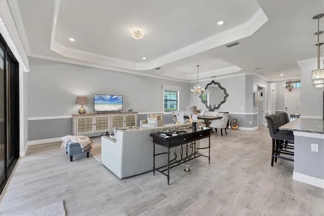a kitchen with kitchen island granite countertop a table chairs microwave and cabinets