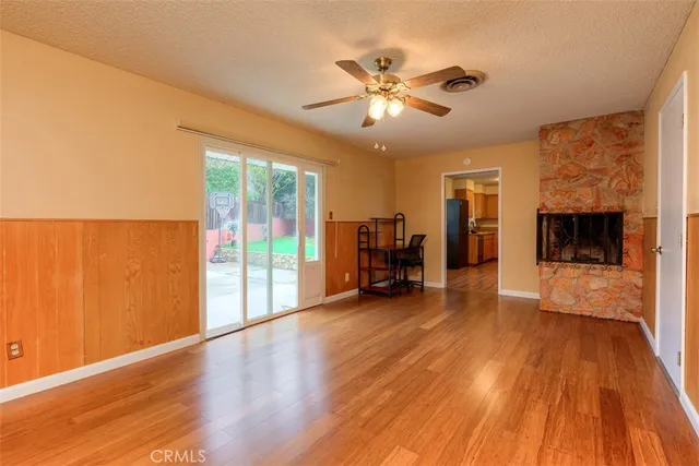 a view of a livingroom with furniture a ceiling fan and wooden floor