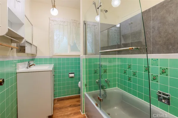 a bathroom with a shower a mirror and a sink