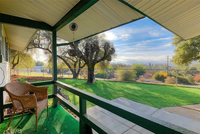 a view of a backyard with sitting area