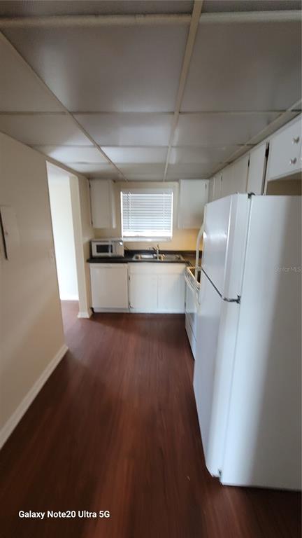122 North Kings Avenue, Unit 202 Brandon, FL 33510 - Photo 2 of 12 a kitchen with a refrigerator a sink and a stove