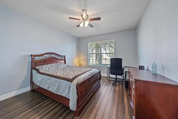 a bedroom with a bed and a desk