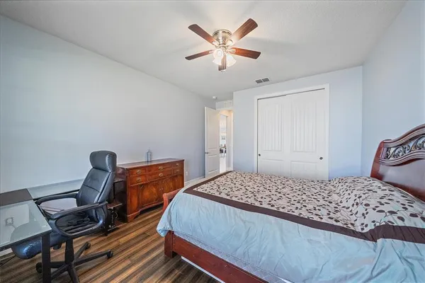 a bedroom with a bed and a desk