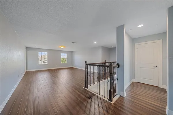 a view of gallery with wooden floor