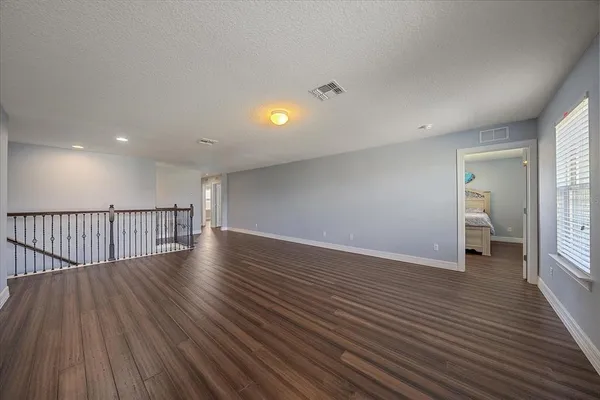 a view of a room with wooden floor