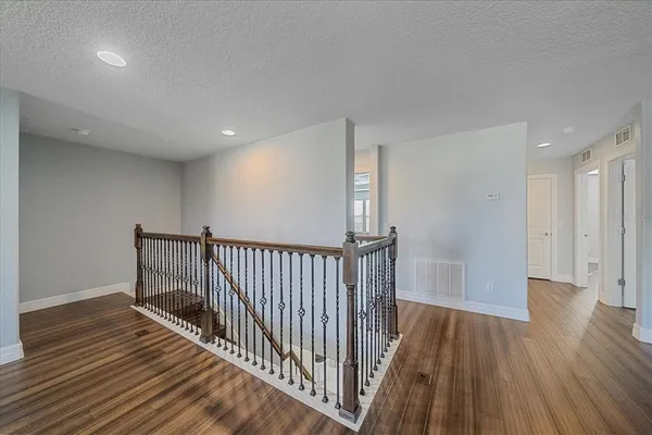 a view of a hallway with wooden floor