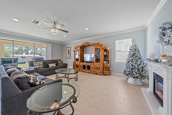 a living room with furniture large window and a chandelier
