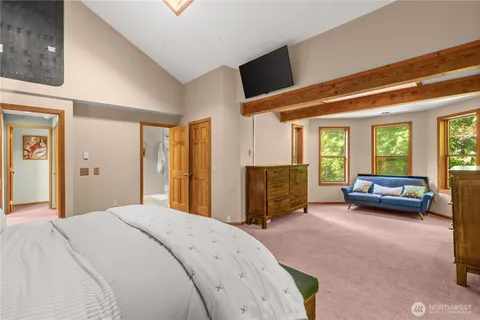 a spacious bedroom with a bed and a couch