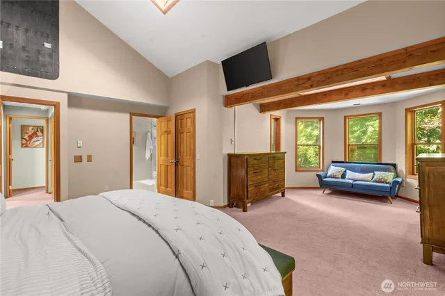 a spacious bedroom with a bed and a couch