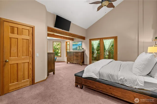 a bedroom with a bed and large window