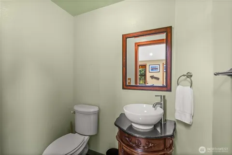 a bathroom with a toilet and a mirror