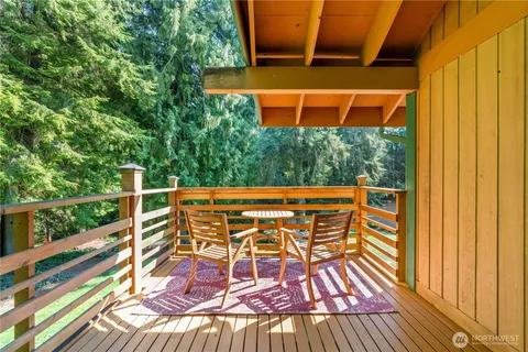 a view of balcony with wooden floor and outdoor seating
