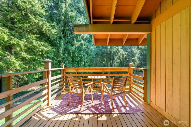 a view of balcony with wooden floor and outdoor seating