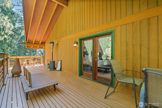 a view of a balcony with chairs and wooden floor