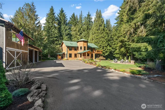 a front view of a house with a yard and trees
